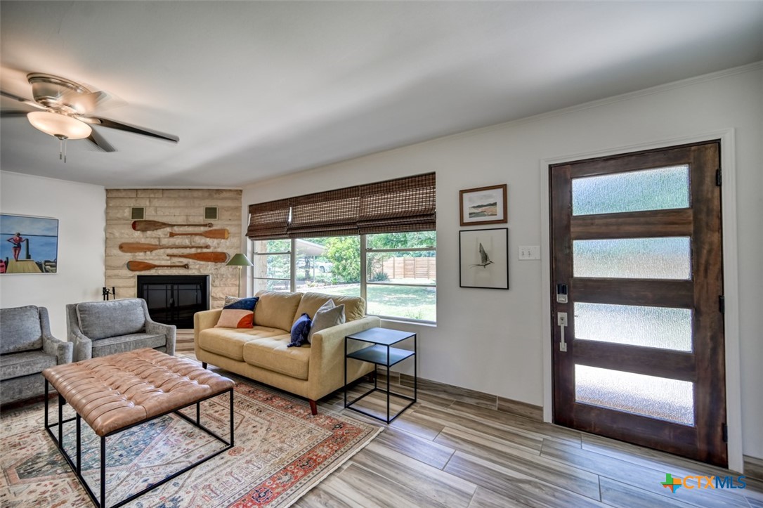 644 Cypress Ridge Road McQueeney, TX 78123 - Photo 11 of 45 a living room with furniture fireplace and flat screen tv