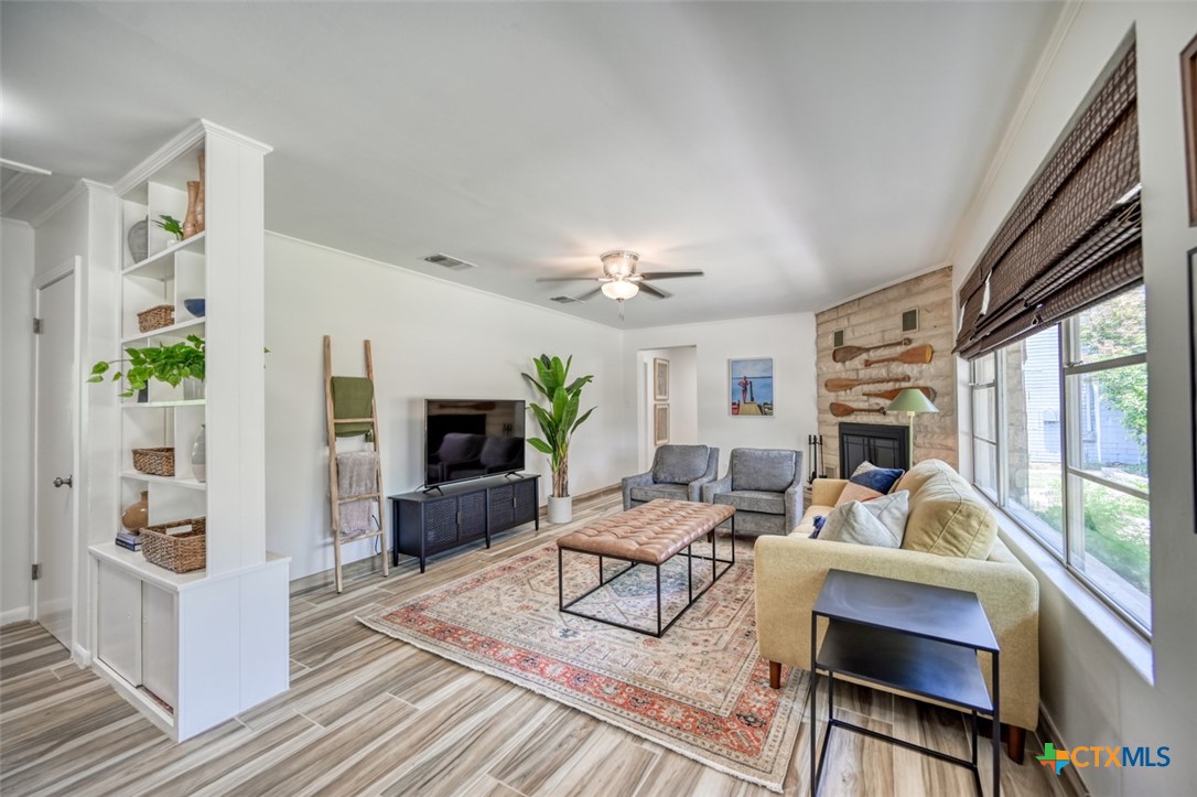 644 Cypress Ridge Road McQueeney, TX 78123 - Photo 12 of 45 a living room with furniture a flat screen tv and a fireplace