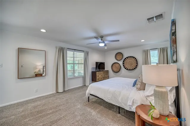a view of a patio with table and chairs and potted plants