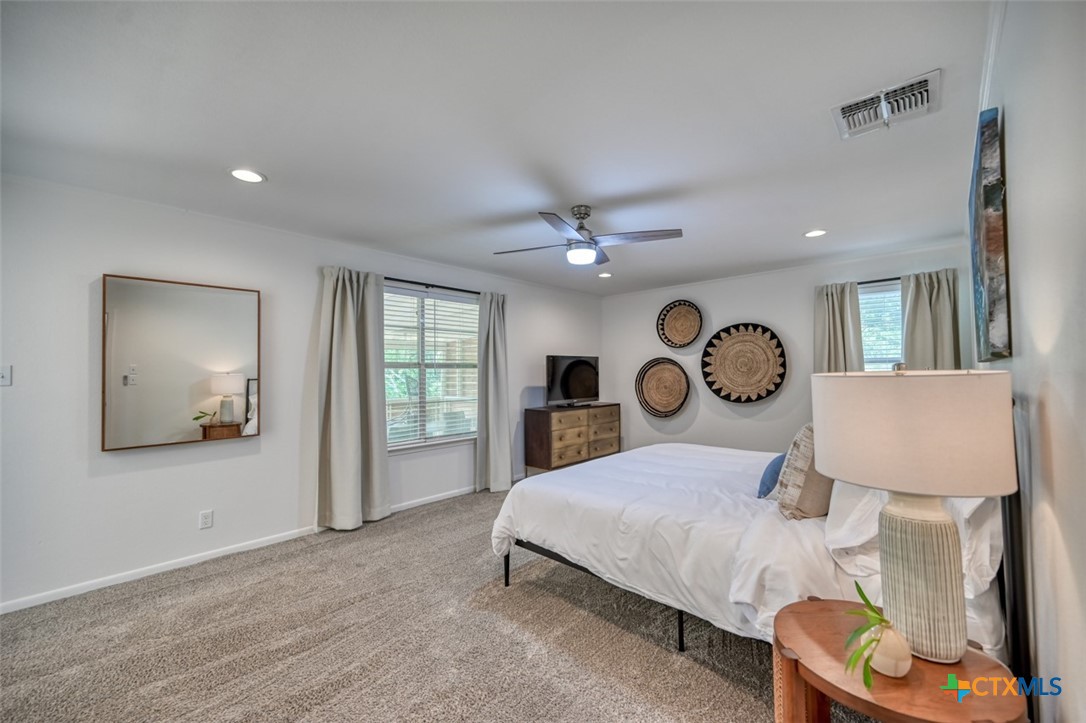 644 Cypress Ridge Road McQueeney, TX 78123 - Photo 19 of 45 a bed room with a bed mirror and a window