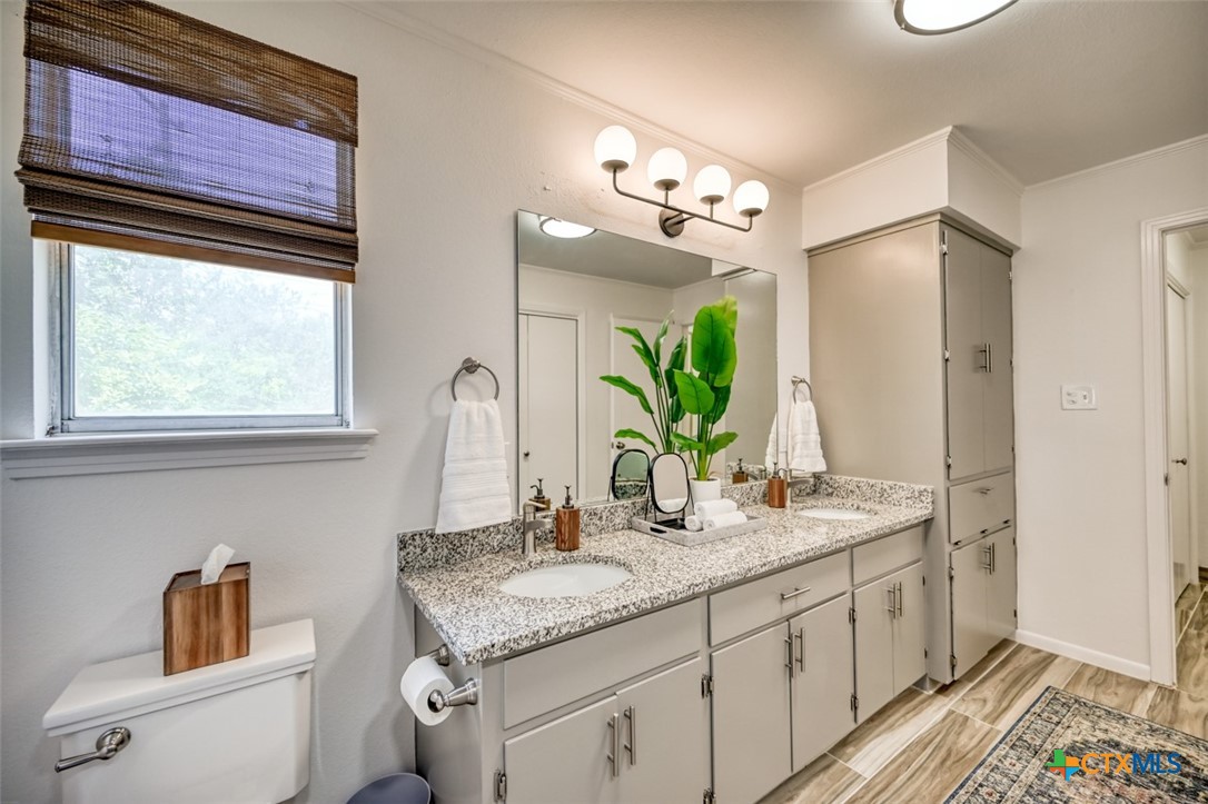 644 Cypress Ridge Road McQueeney, TX 78123 - Photo 23 of 45 a bathroom with a granite countertop sink and a mirror