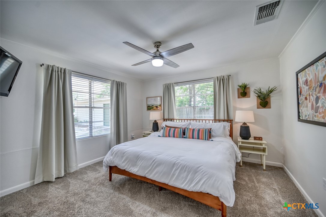 644 Cypress Ridge Road McQueeney, TX 78123 - Photo 24 of 45 a bedroom with a large bed and a window