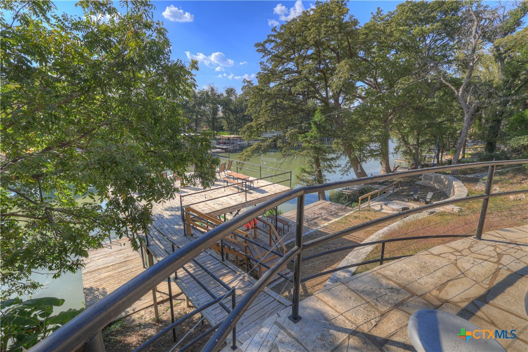644 Cypress Ridge Road McQueeney, TX 78123 - Photo 29 of 45 a view of a balcony with two chairs and a table