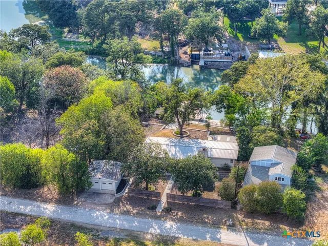 a living room with furniture a fireplace and a floor to ceiling window