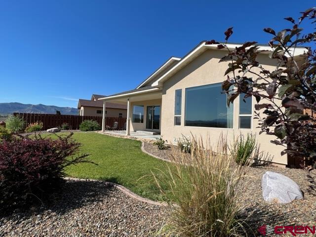 802 L Way Cortez, CO 81321 - Photo 18 of 21 a front view of a house with garden