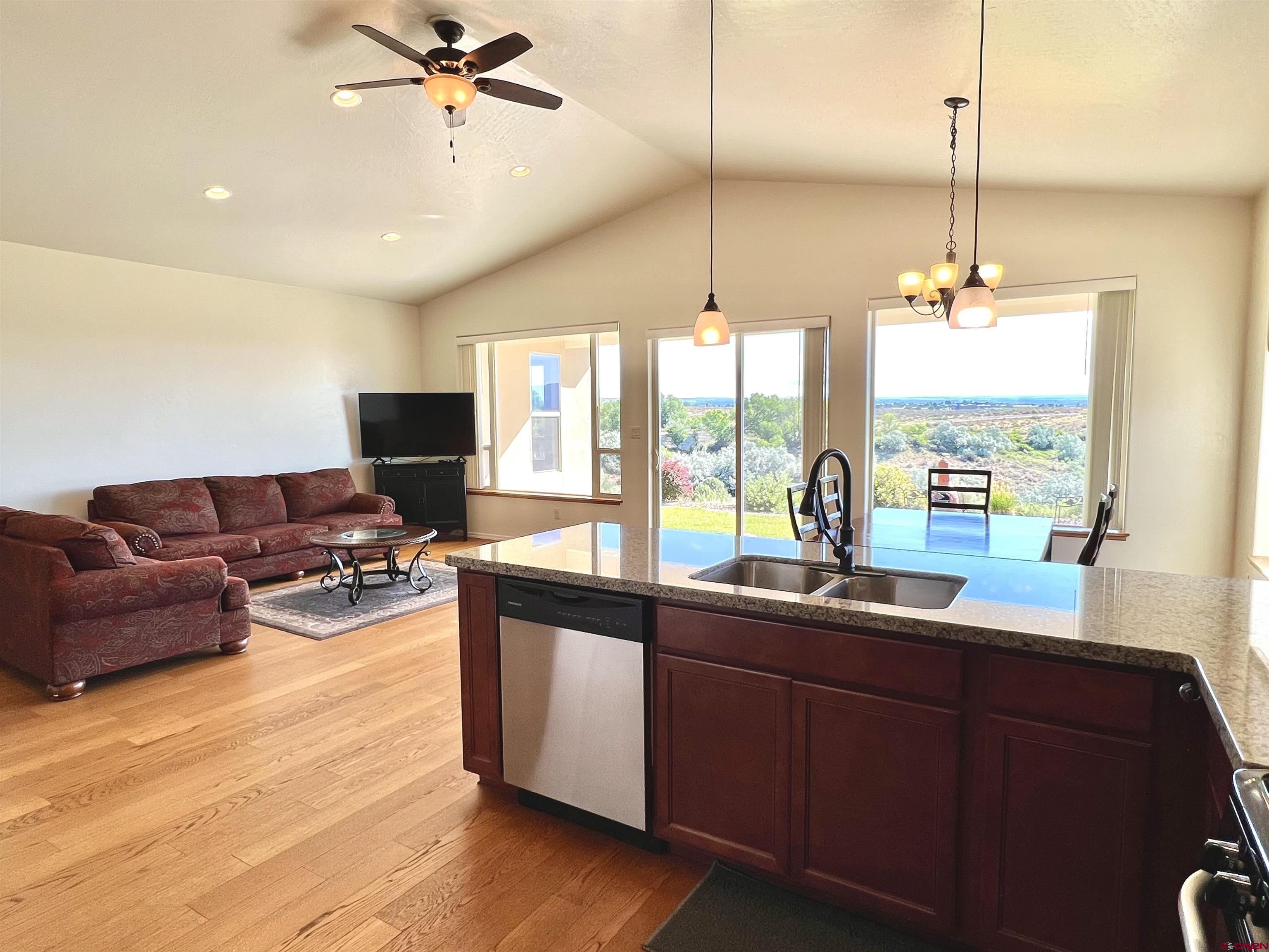 802 L Way Cortez, CO 81321 - Photo 5 of 21 a kitchen with stainless steel appliances granite countertop sink stove and living room