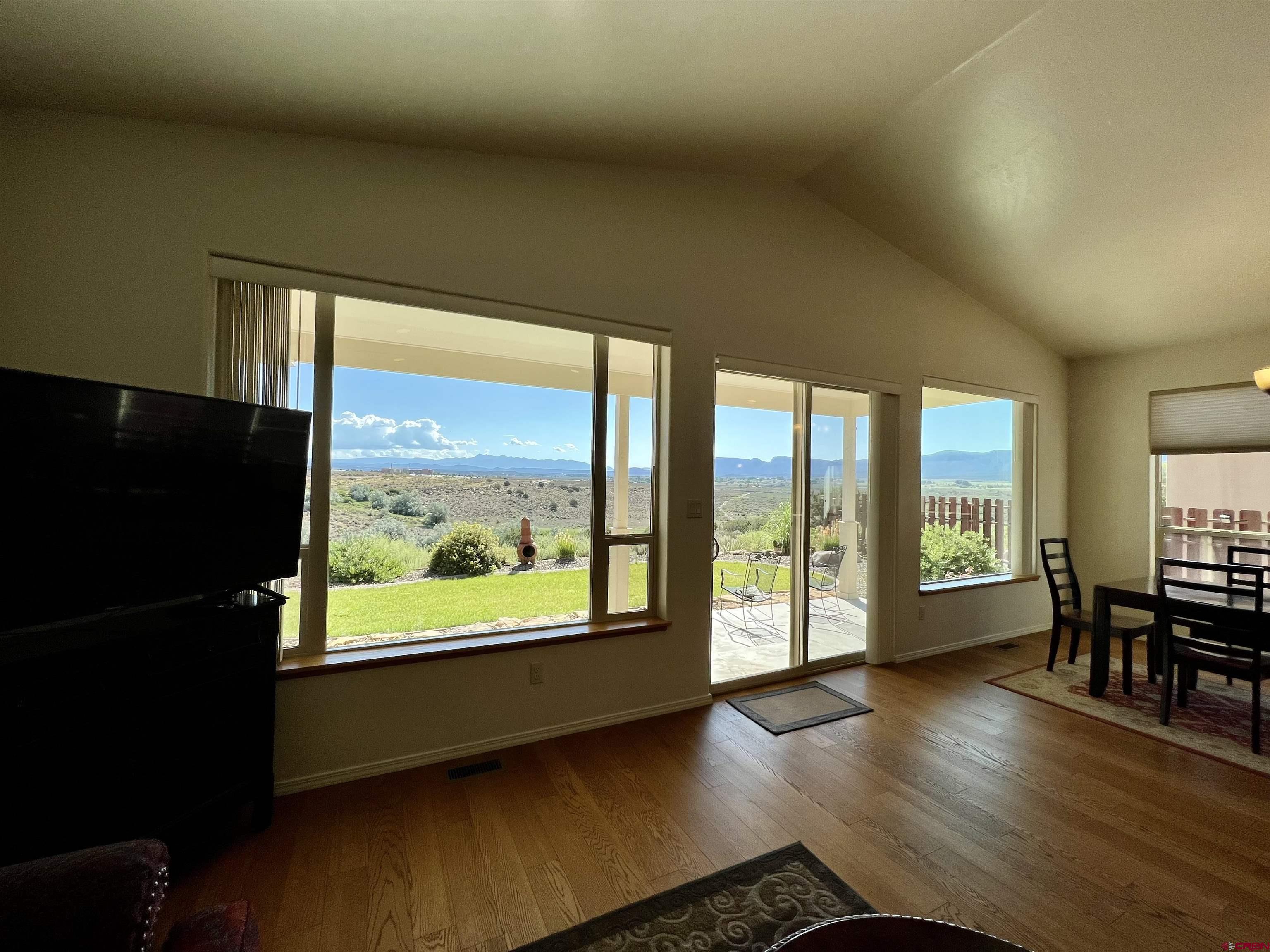 802 L Way Cortez, CO 81321 - Photo 8 of 21 a view of an empty room with wooden floor and a window