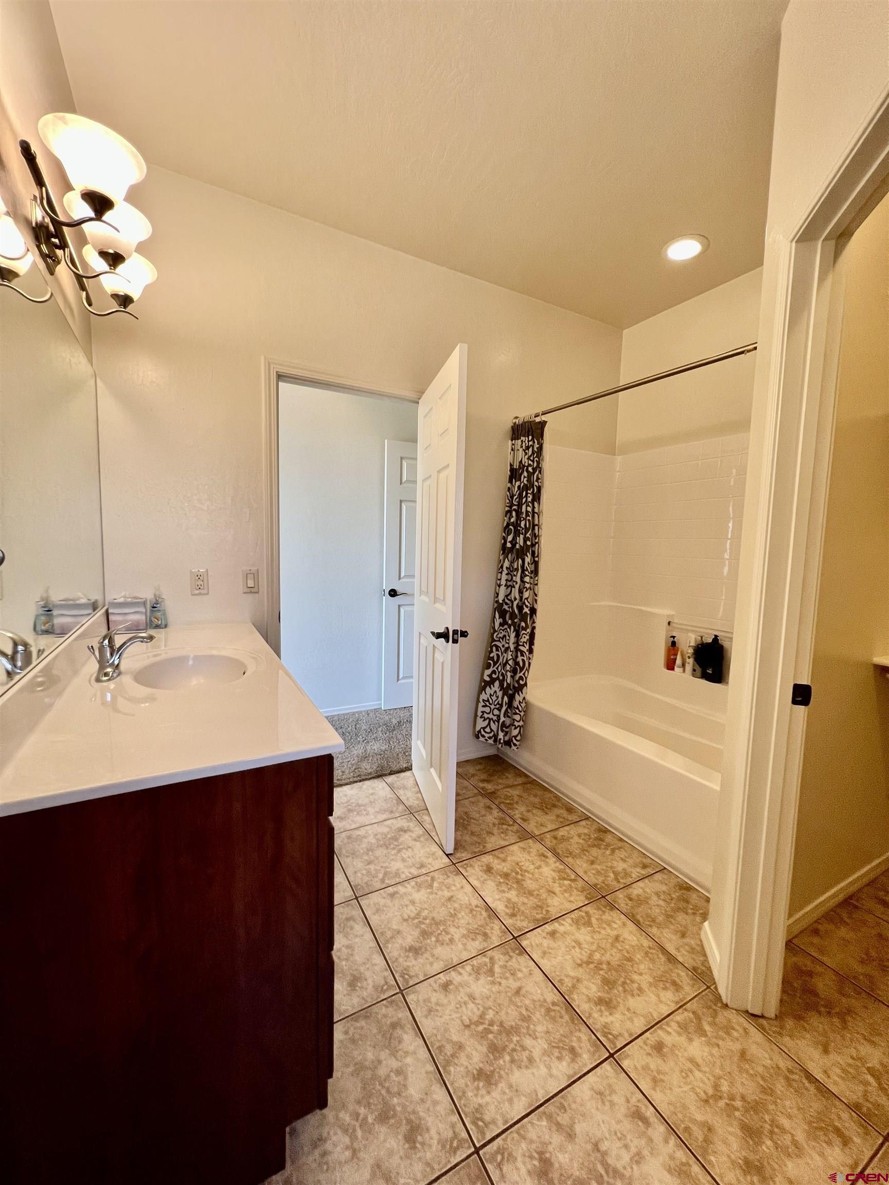 802 L Way Cortez, CO 81321 - Photo 10 of 21 a bathroom with a sink a mirror and a bathtub