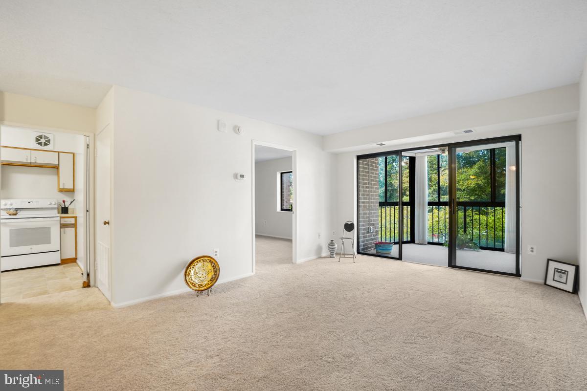 15107 Interlachen Drive, Unit 2321 Silver Spring, MD 20906 - Photo 13 of 35 a view of a bedroom with a bed and a large window