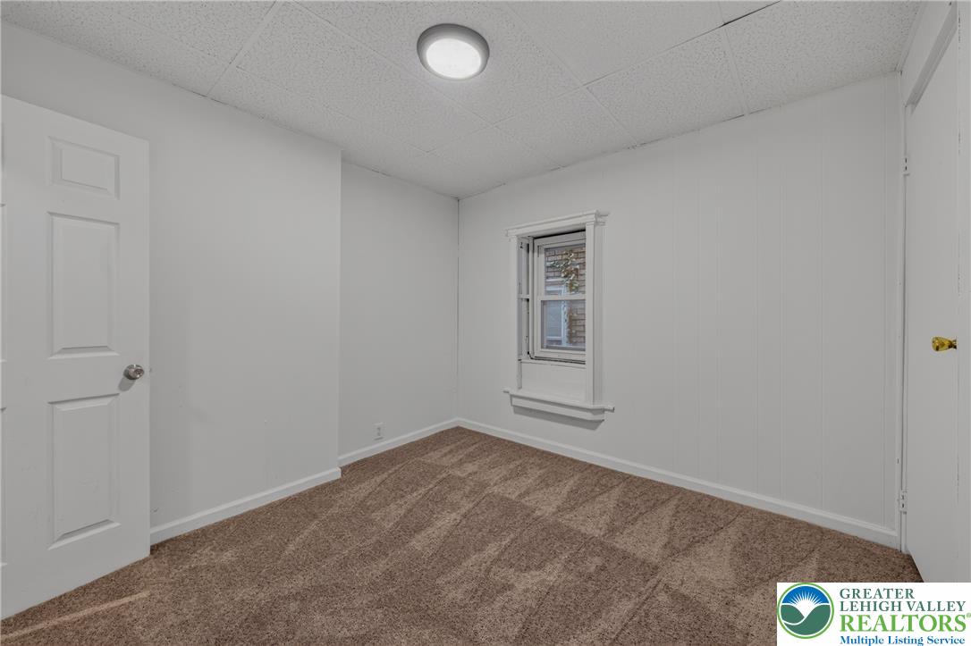 313 Main Street Slatington, PA 18080 - Photo 22 of 73 A well-maintained room featuring textured carpet flooring and a single window.