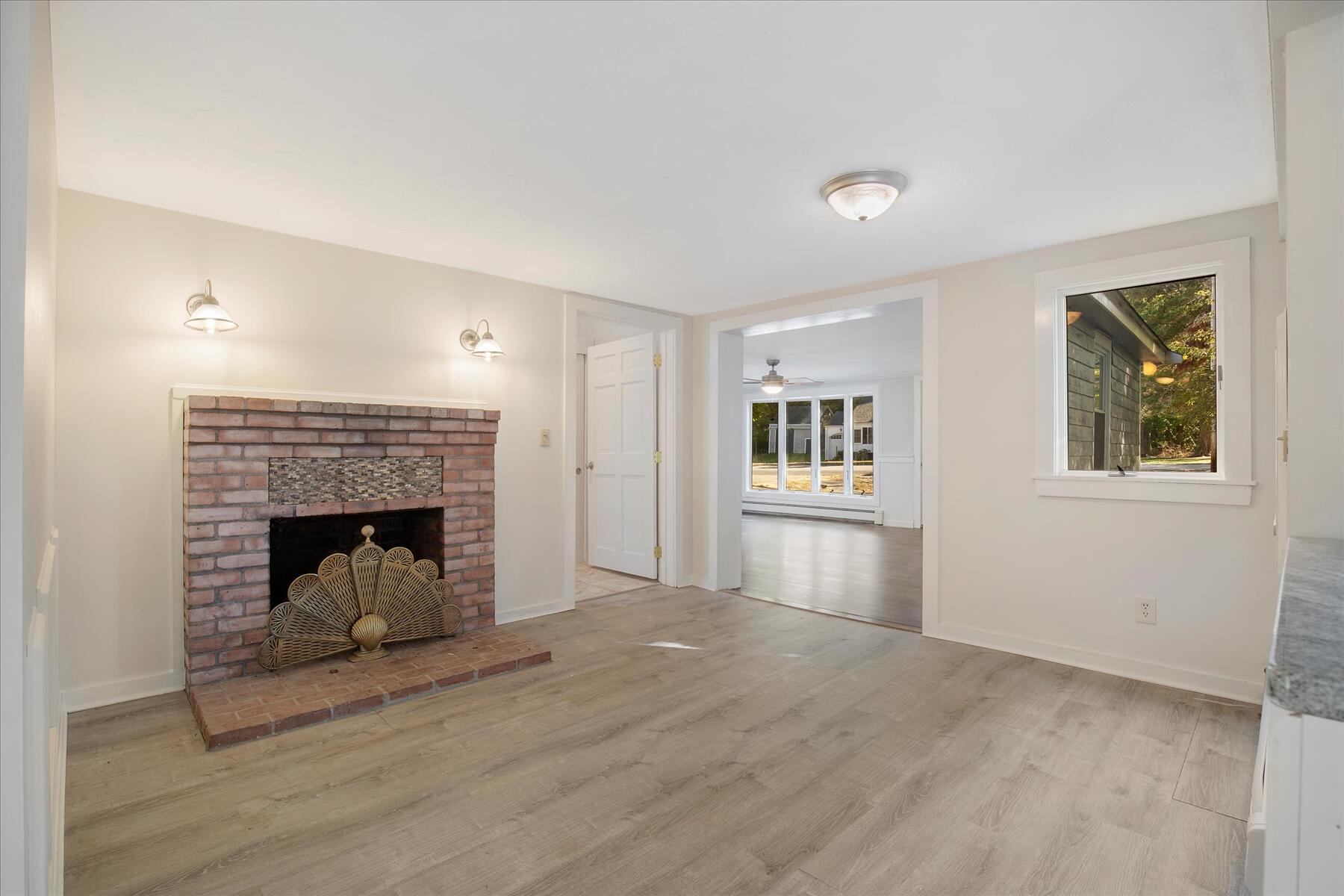 254 Barlows Landing Road Pocasset, MA 02559 - Photo 5 of 27 a view of a livingroom with a fireplace wooden floor and window