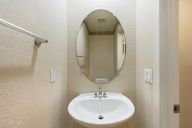 a bathroom with a sink and mirror