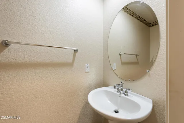 a bathroom with a sink and mirror