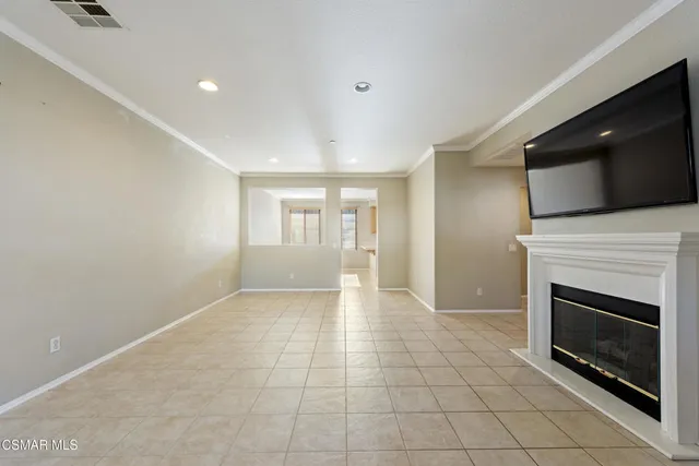 a view of an empty room with a fireplace