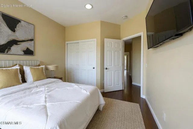a bedroom with a bed and cabinets