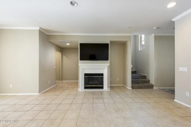 a view of an empty room with a fireplace