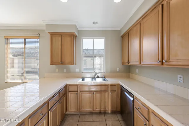 a kitchen with a sink cabinets and window