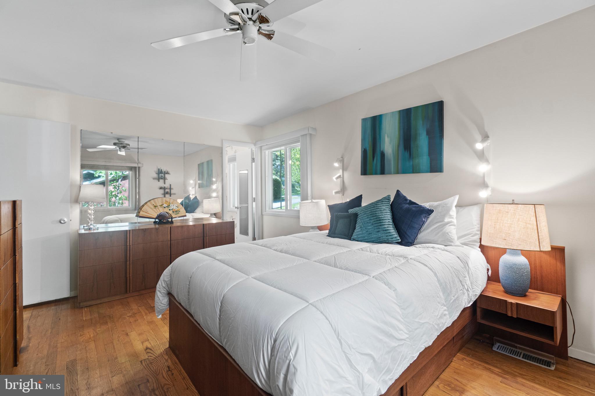 11318 Myrtle Lane Reston, VA 20191 - Photo 25 of 40 a bedroom with a bed and a chandelier