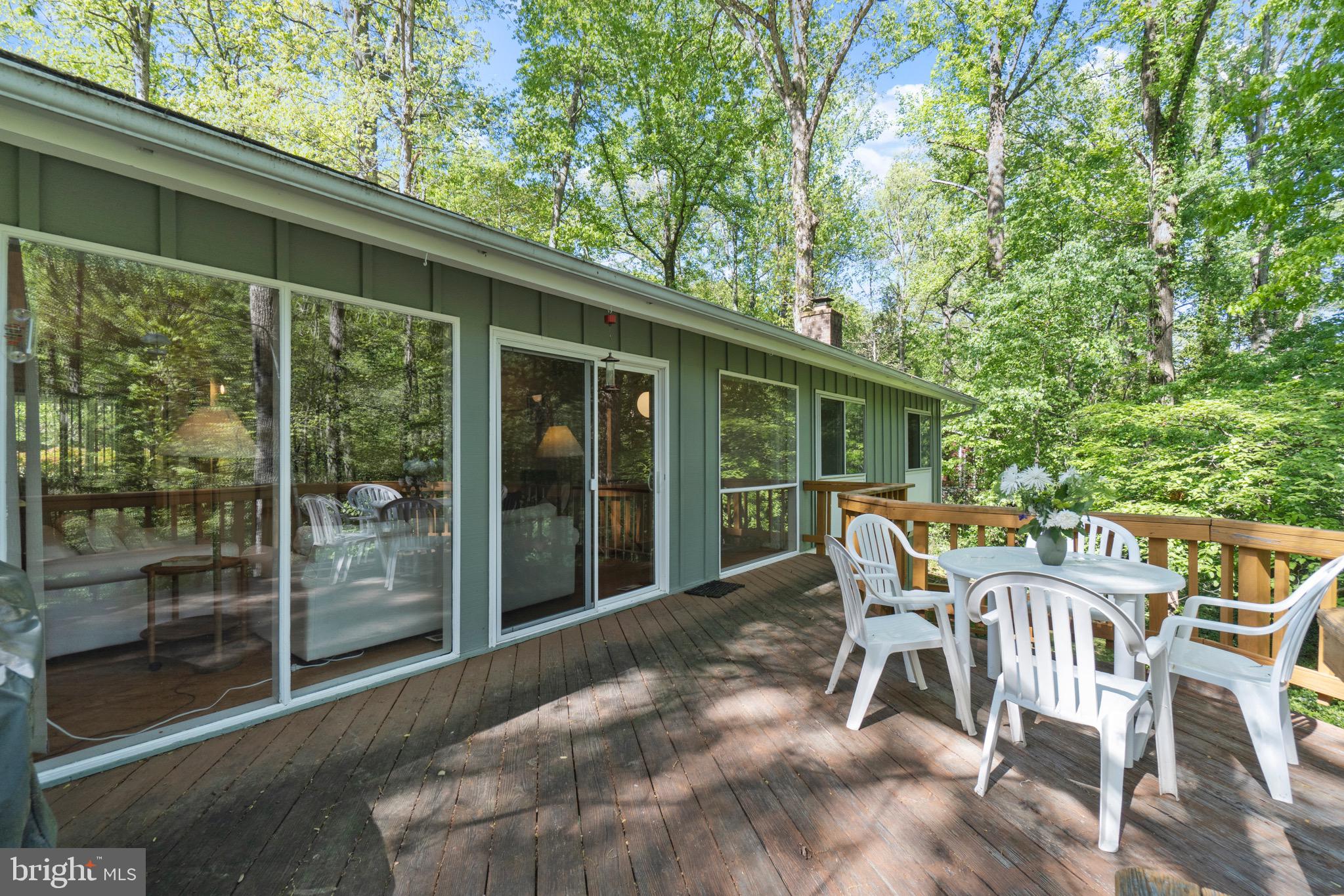 11318 Myrtle Lane Reston, VA 20191 - Photo 37 of 40 a view of a patio with table and chairs and floor to ceiling window