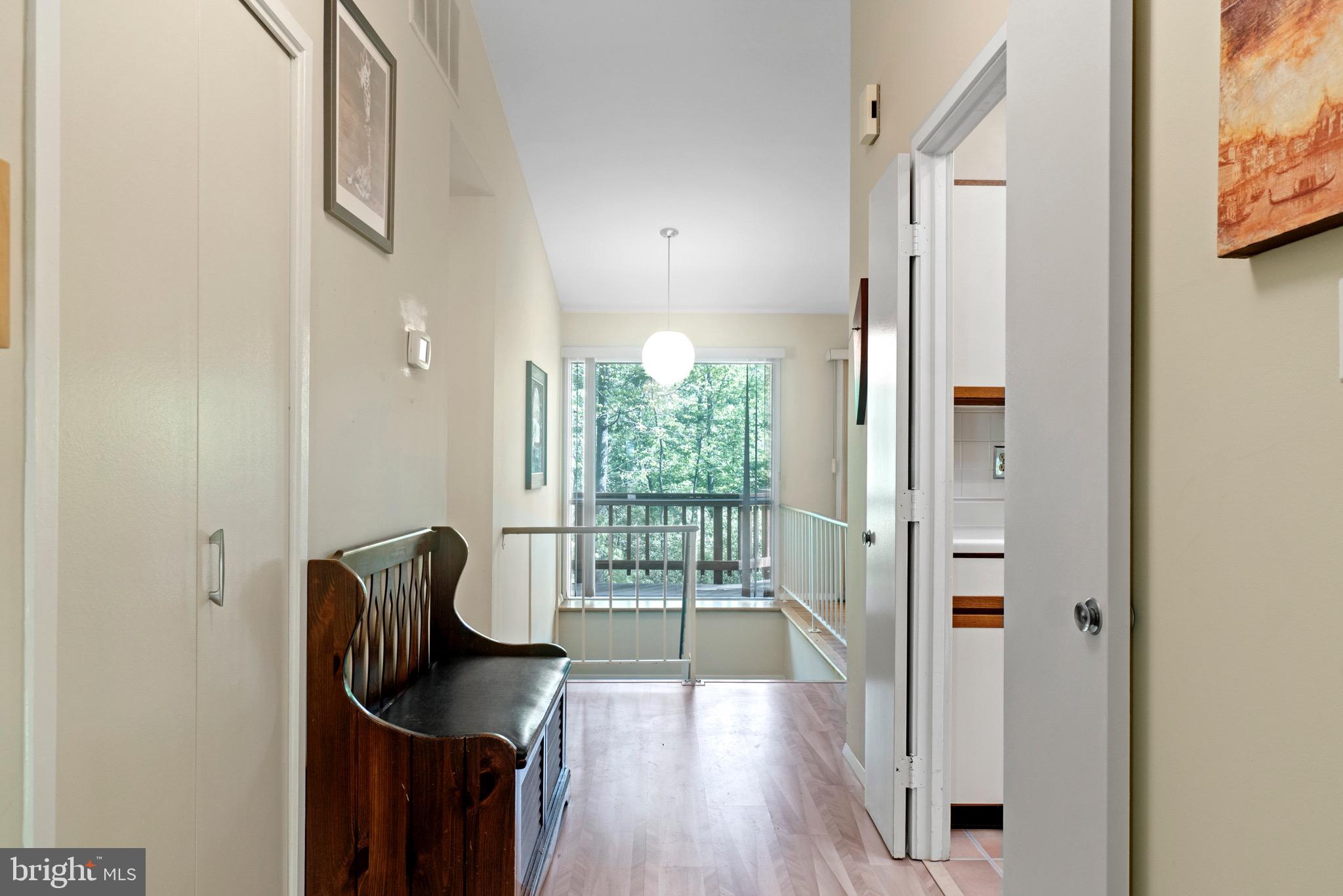 11318 Myrtle Lane Reston, VA 20191 - Photo 5 of 40 a view of a hallway with wooden floor and glass door