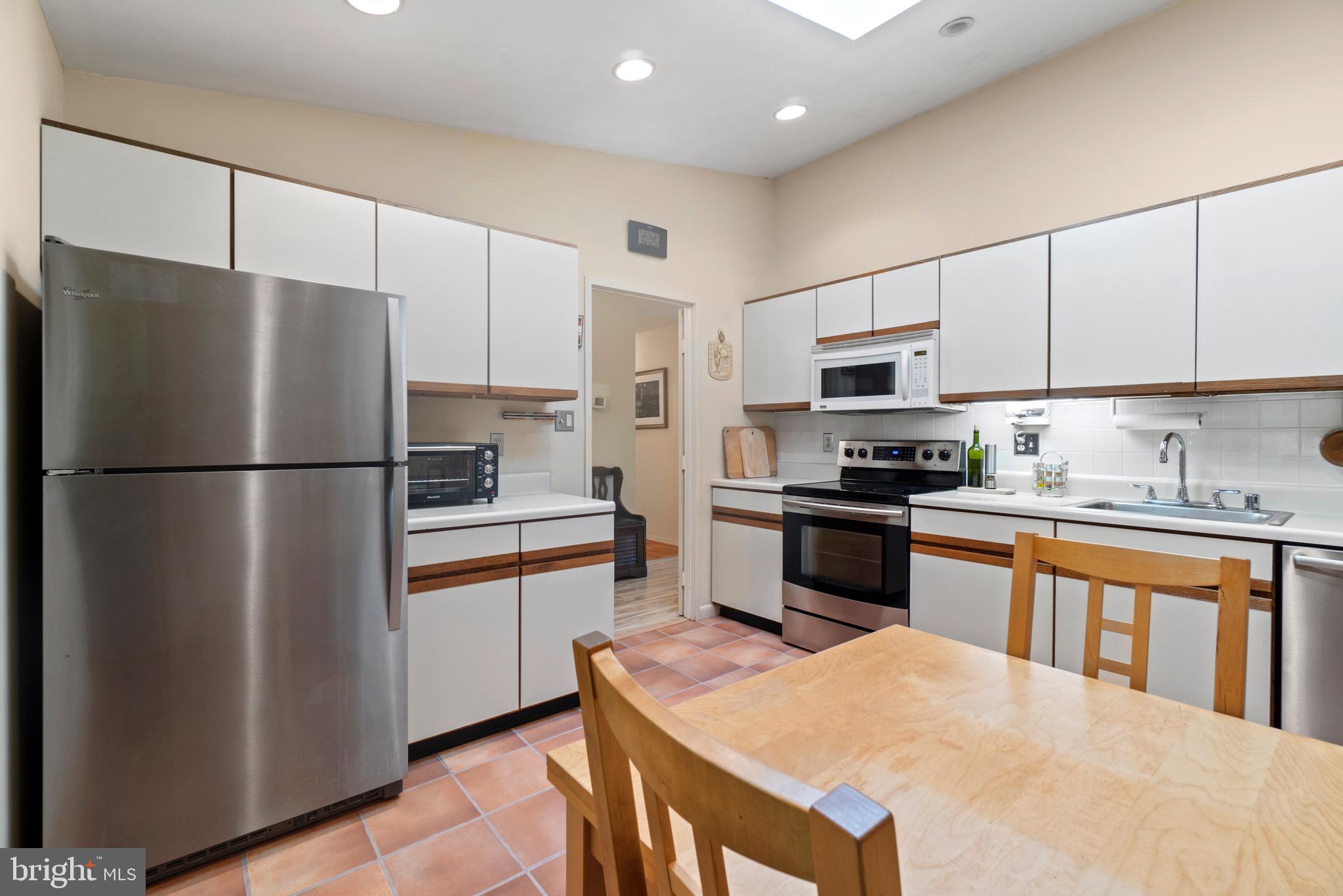 11318 Myrtle Lane Reston, VA 20191 - Photo 7 of 40 a kitchen with stainless steel appliances granite countertop a refrigerator stove a sink and a microwave