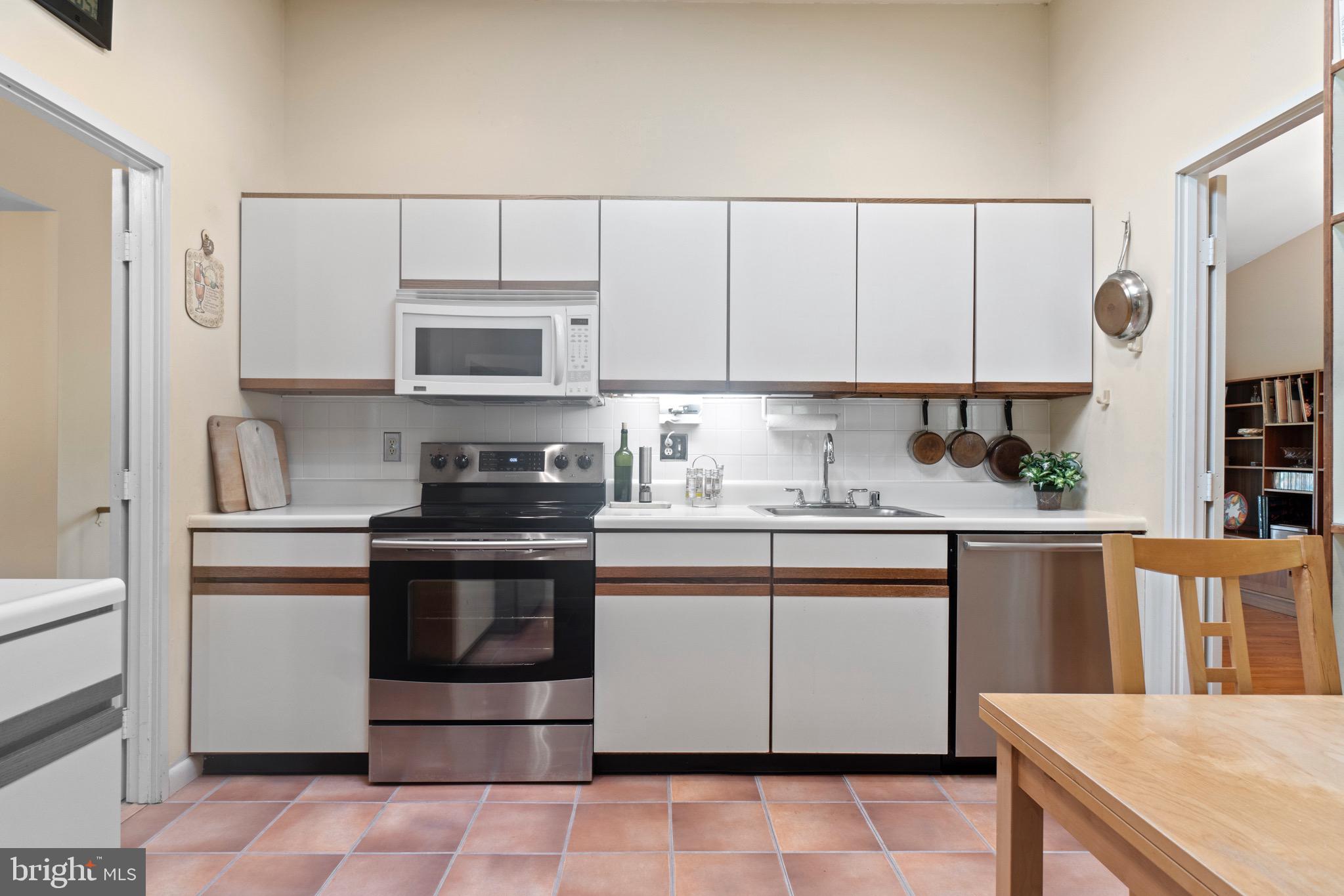 11318 Myrtle Lane Reston, VA 20191 - Photo 8 of 40 a kitchen with stainless steel appliances granite countertop a stove a sink and a refrigerator