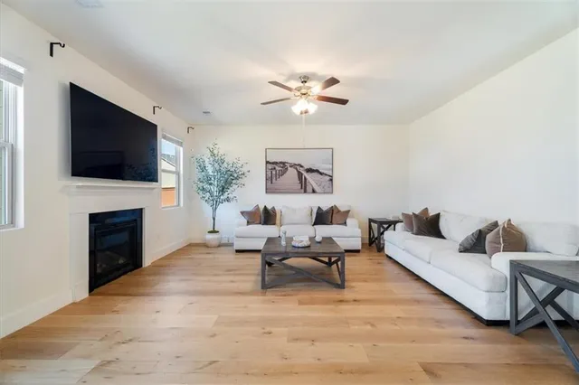 a living room with furniture a fireplace and a flat screen tv