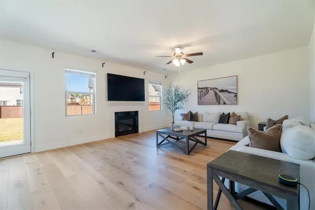 a living room with furniture a fireplace and a flat screen tv