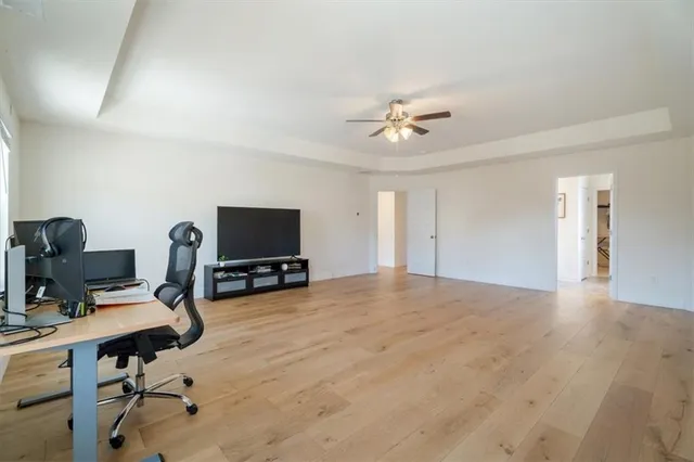 a view of a workspace with furniture and a window