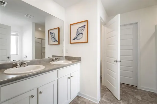 a bathroom with a granite countertop sink a mirror a vanity and