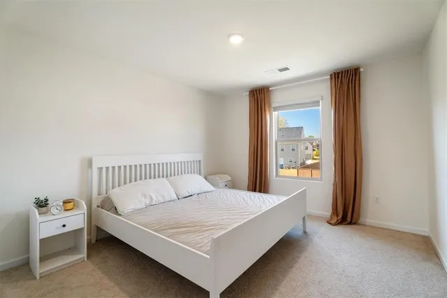 a bed room with a bed and a window