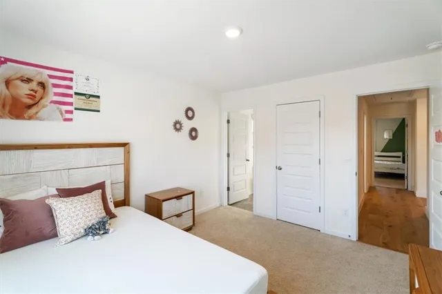 a bedroom with a bed and a lamp