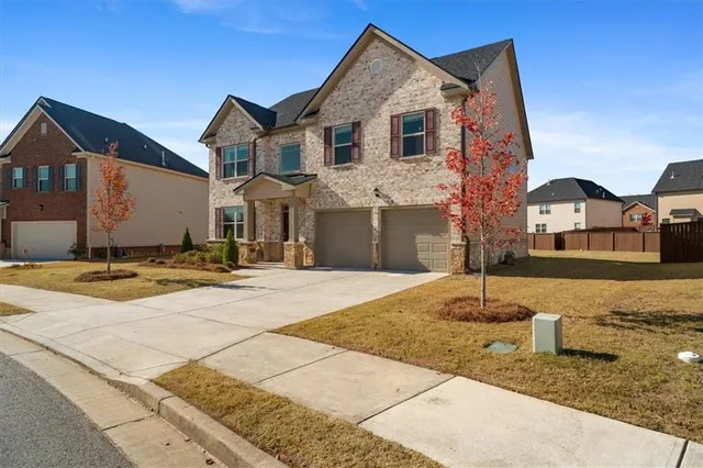 a front view of a house with a yard
