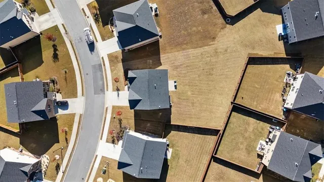 an aerial view of residential houses with outdoor space