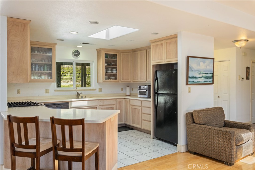 7875 Adobe Creek Road Kelseyville, CA 95451 - Photo 13 of 51 a kitchen with a refrigerator a stove a sink and dishwasher with wooden floor