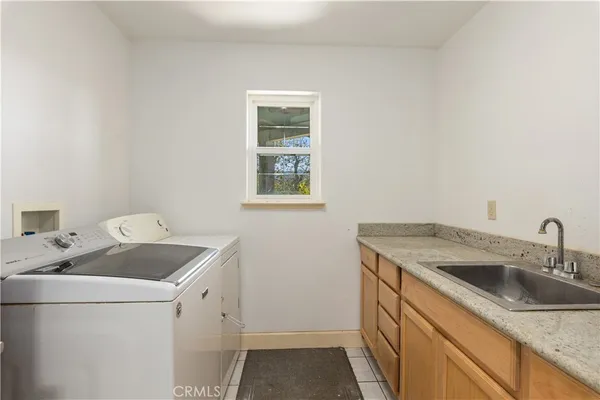 a utility room with sink washer and dryer