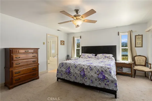 a bedroom with a bed and ceiling fan