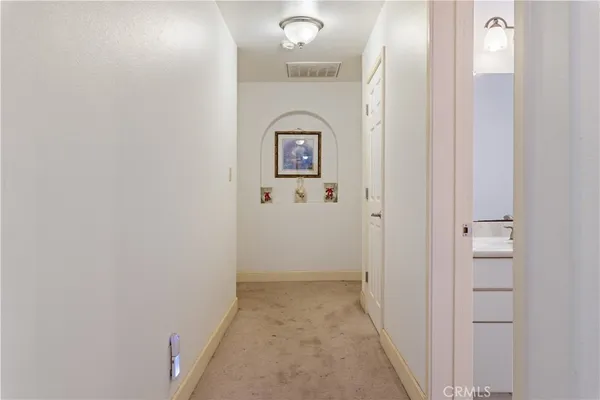 a view of a hallway with a door to a hallway