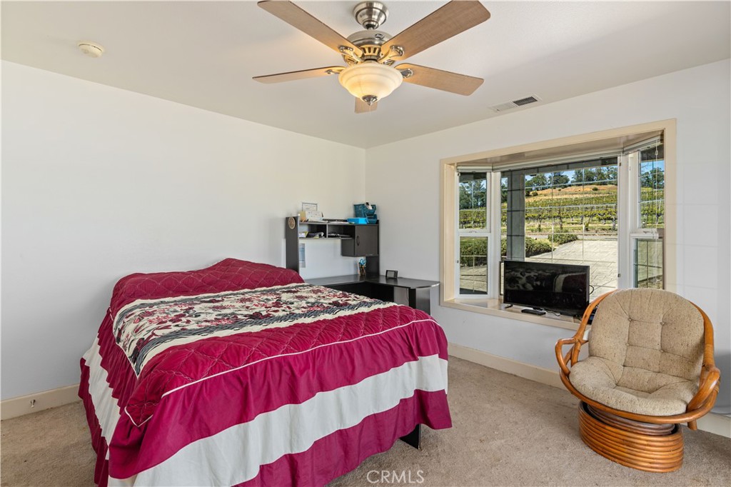 7875 Adobe Creek Road Kelseyville, CA 95451 - Photo 23 of 51 a bedroom with a bed and a fireplace