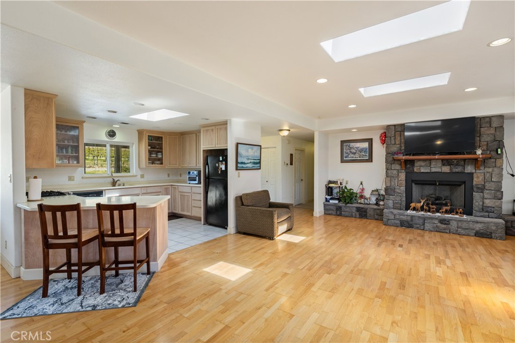 7875 Adobe Creek Road Kelseyville, CA 95451 - Photo 9 of 51 a living room with furniture a fireplace kitchen view and a large window