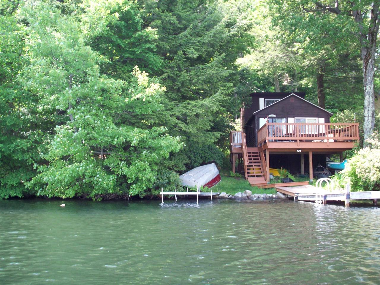 289 Old Pond Road Becket, MA 01223 - Photo 1 of 6 an aerial view of a house with swimming pool and lake view