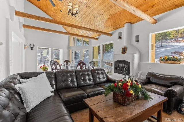 a living room with furniture flowerpot and wooden floor