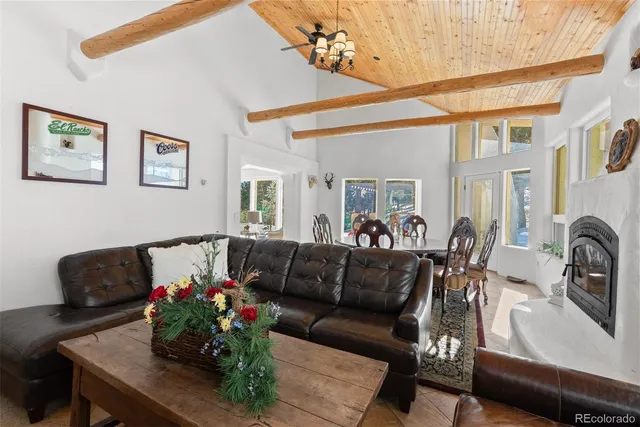 a dining room with furniture a flat screen tv and windows