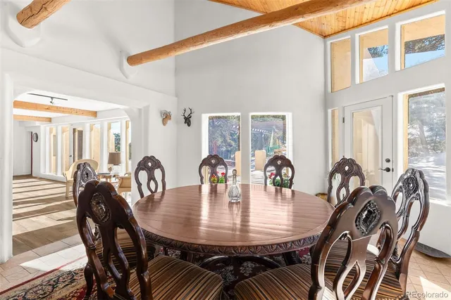 a room with lots of white furniture and a window