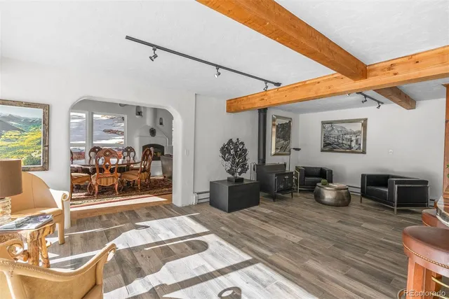 a dining room with furniture and wooden floor