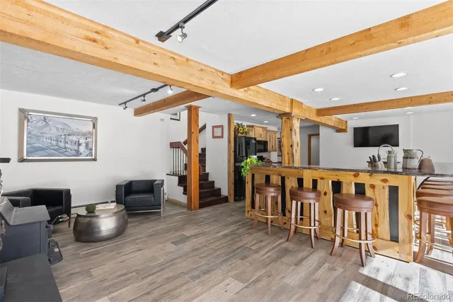 a kitchen with stainless steel appliances kitchen island granite countertop a table and chairs in it