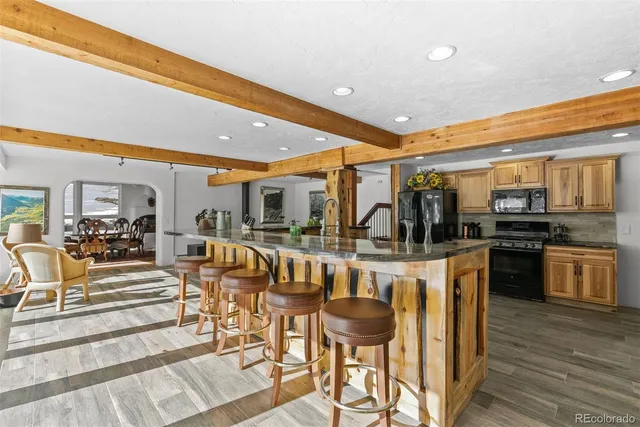 a kitchen with stainless steel appliances granite countertop a sink and wooden cabinets