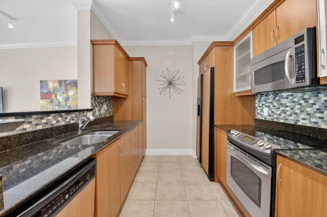 a kitchen with stainless steel appliances a sink and a stove