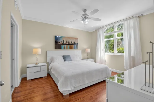 a bedroom with a large bed and a flat tv screen on a dresser
