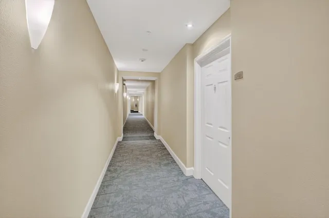 a view of a hallway with a white door